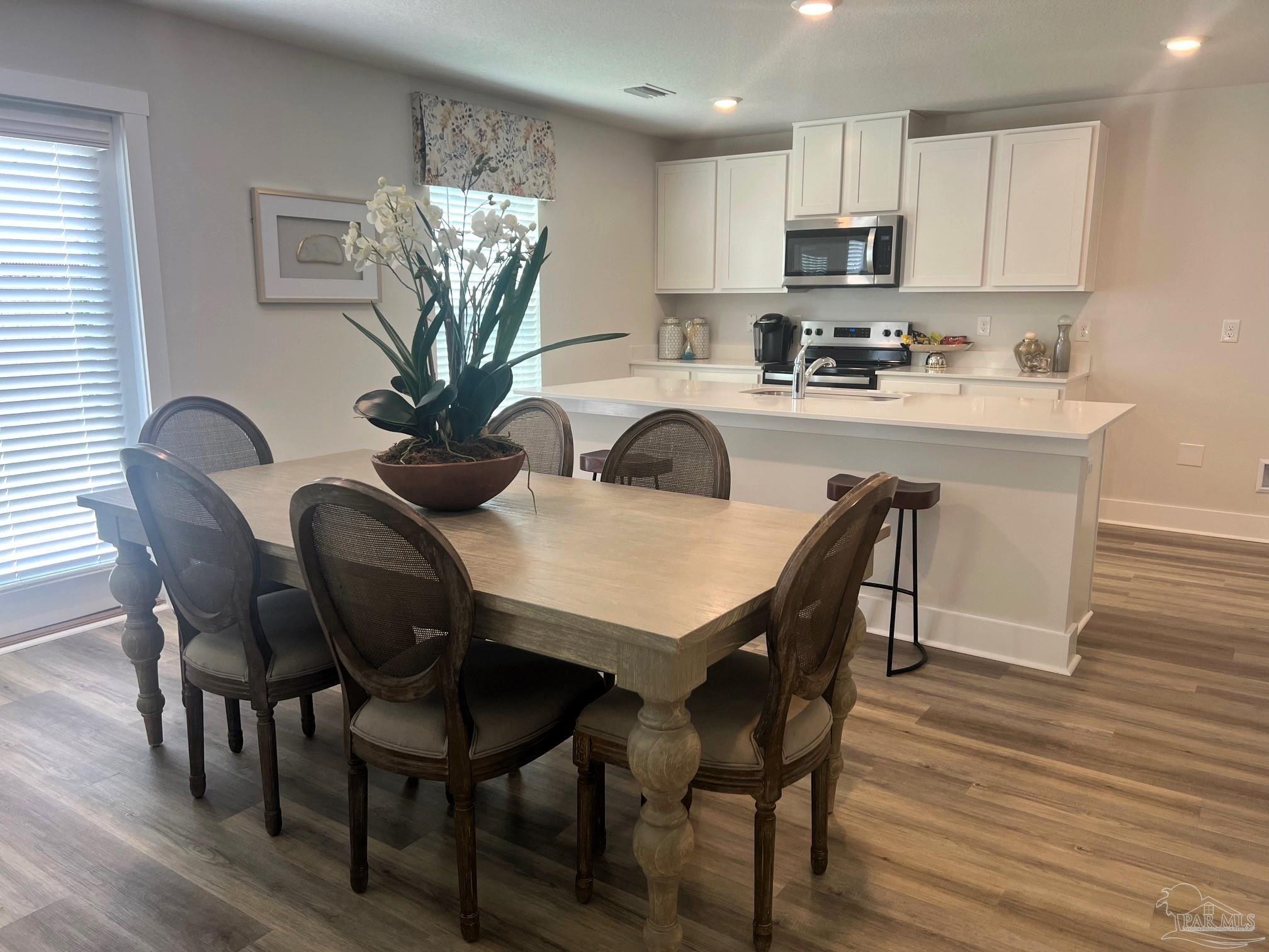 4932 Valor Court Pace, FL 32571 - Photo 4 of 5 a view of a dining room with furniture and wooden floor