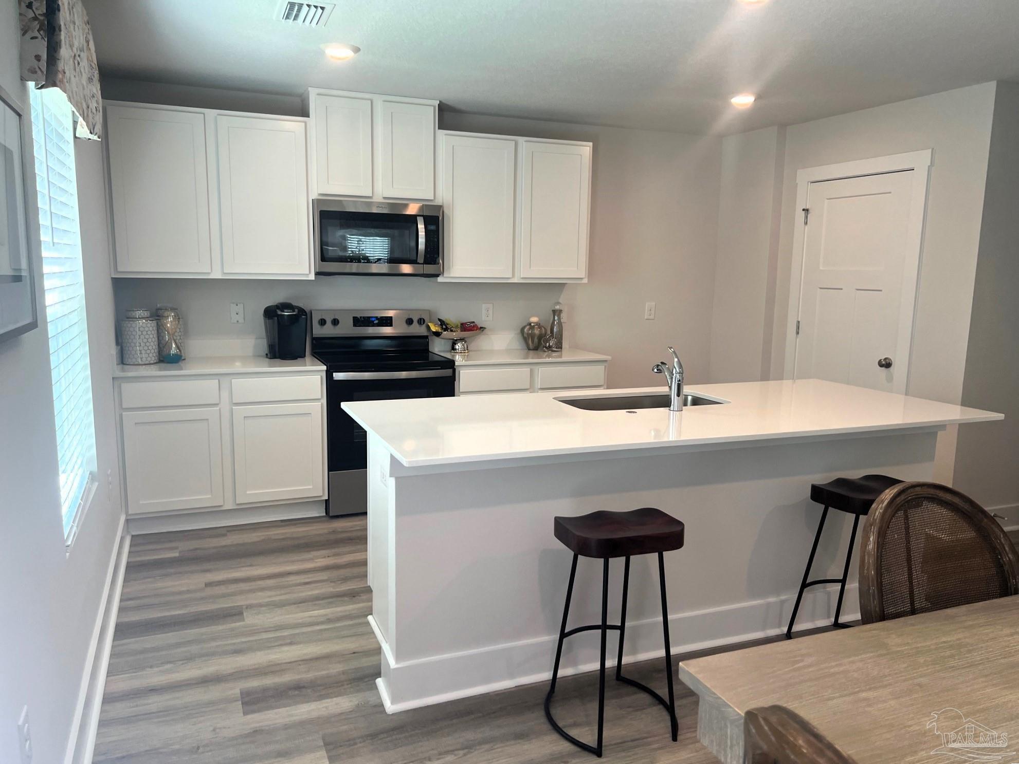 4932 Valor Court Pace, FL 32571 - Photo 5 of 5 a kitchen with a sink cabinets and appliances