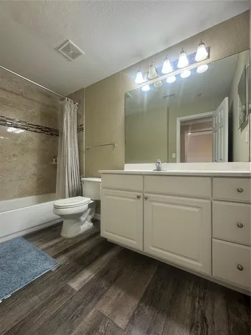 a bathroom with a double vanity sink mirror and toilet
