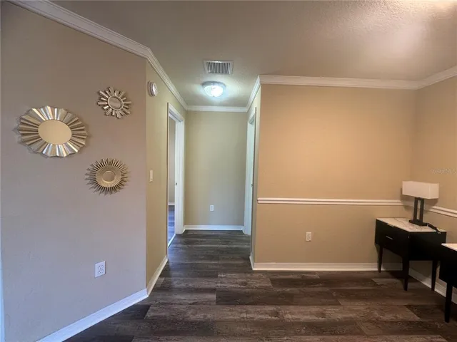a view of a hallway with wooden floor