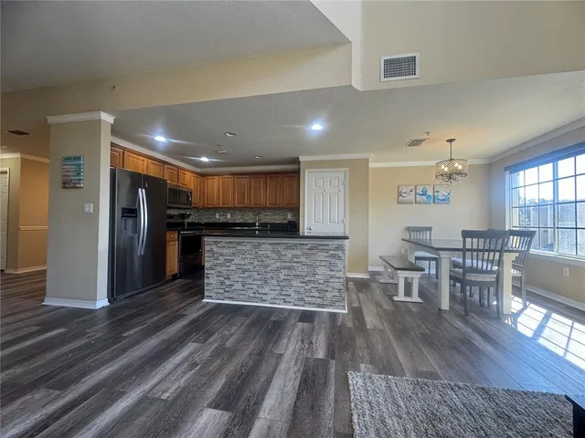 a room with wooden floors and lots of wooden furniture