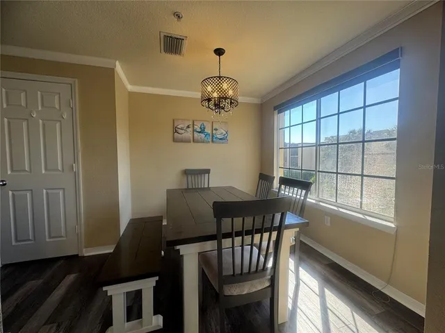 a view of a dining room with furniture window and outside view
