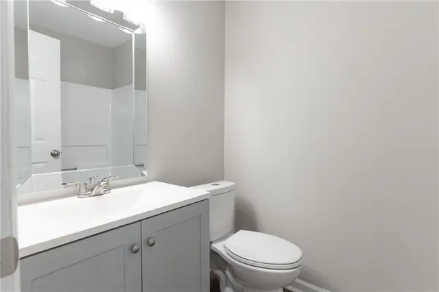 a bathroom with a sink a toilet and mirror