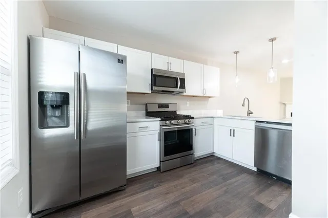 a kitchen with a refrigerator stove and microwave