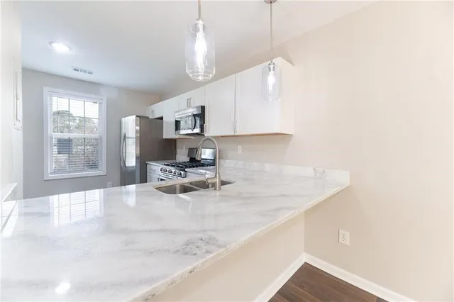 a view of a kitchen with a sink and a window