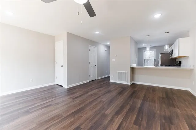a view of a kitchen with wooden floor and a sink