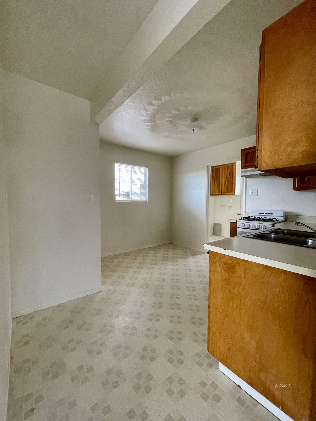 328 North Mono Street Ridgecrest, CA 93555 - Photo 8 of 14 a kitchen with stainless steel appliances granite countertop a sink a stove top oven a counter space and cabinets