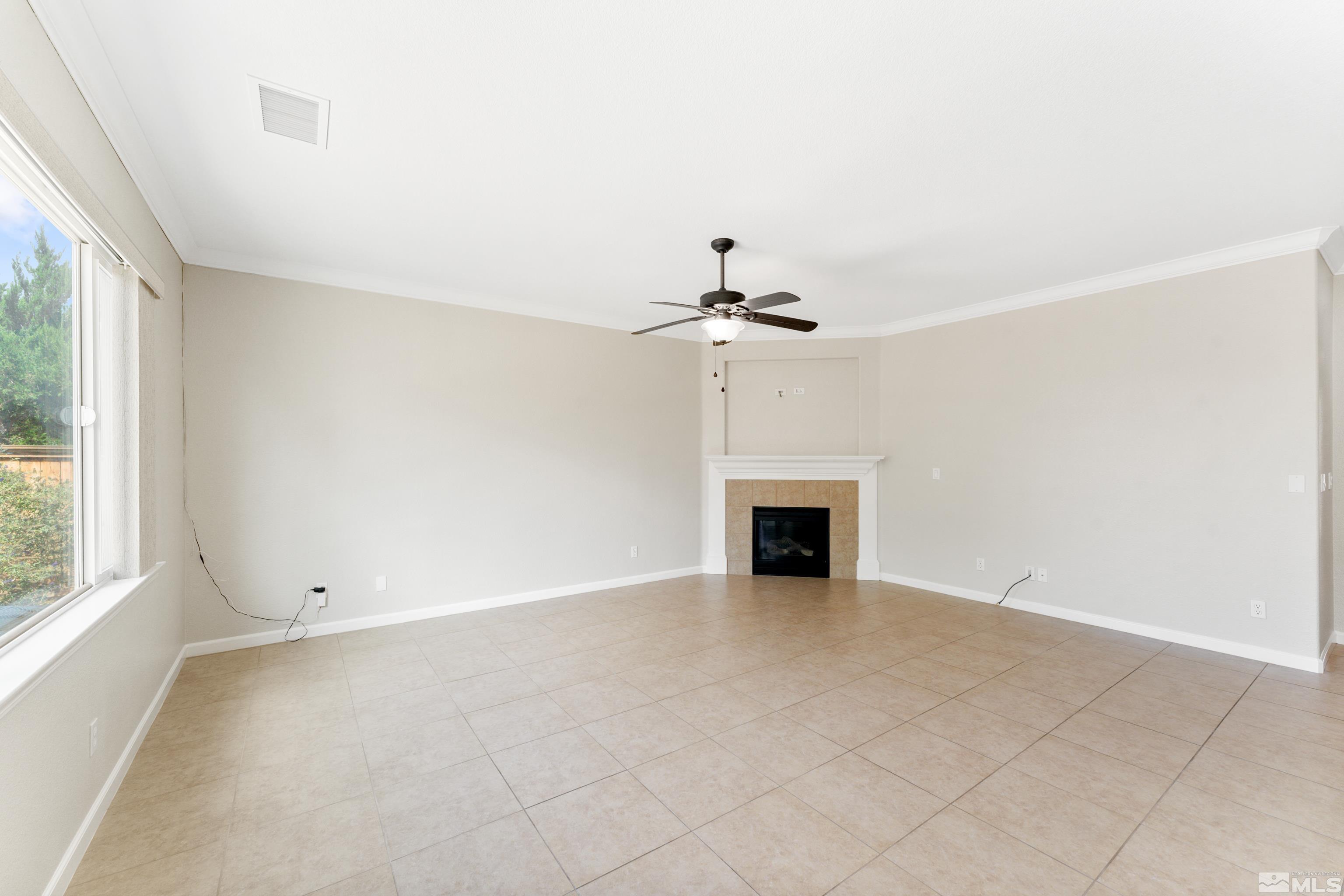 2195 Horse Prairie Road Reno, NV 89521 - Photo 11 of 39 an empty room with chandelier fan and windows