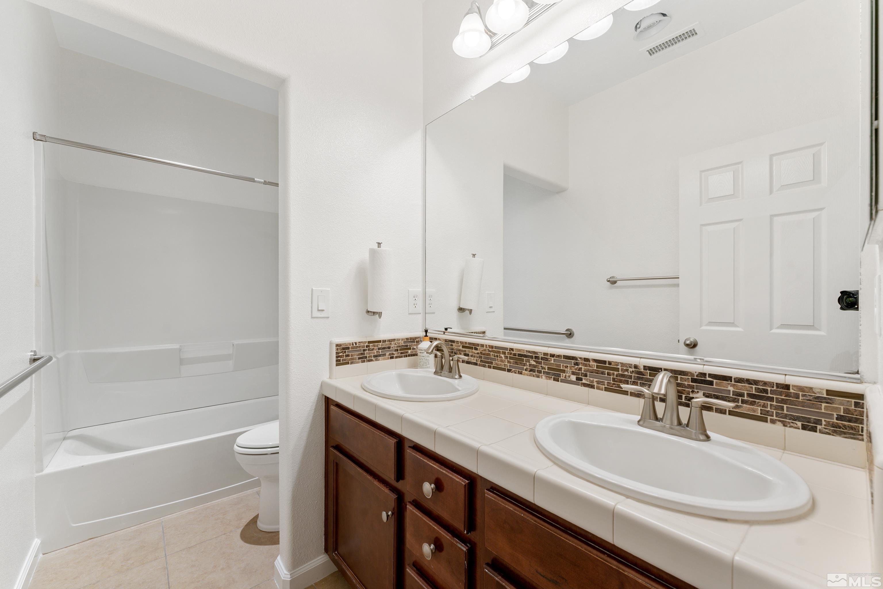 2195 Horse Prairie Road Reno, NV 89521 - Photo 23 of 39 a bathroom with a sink double vanity granite tub and a mirror