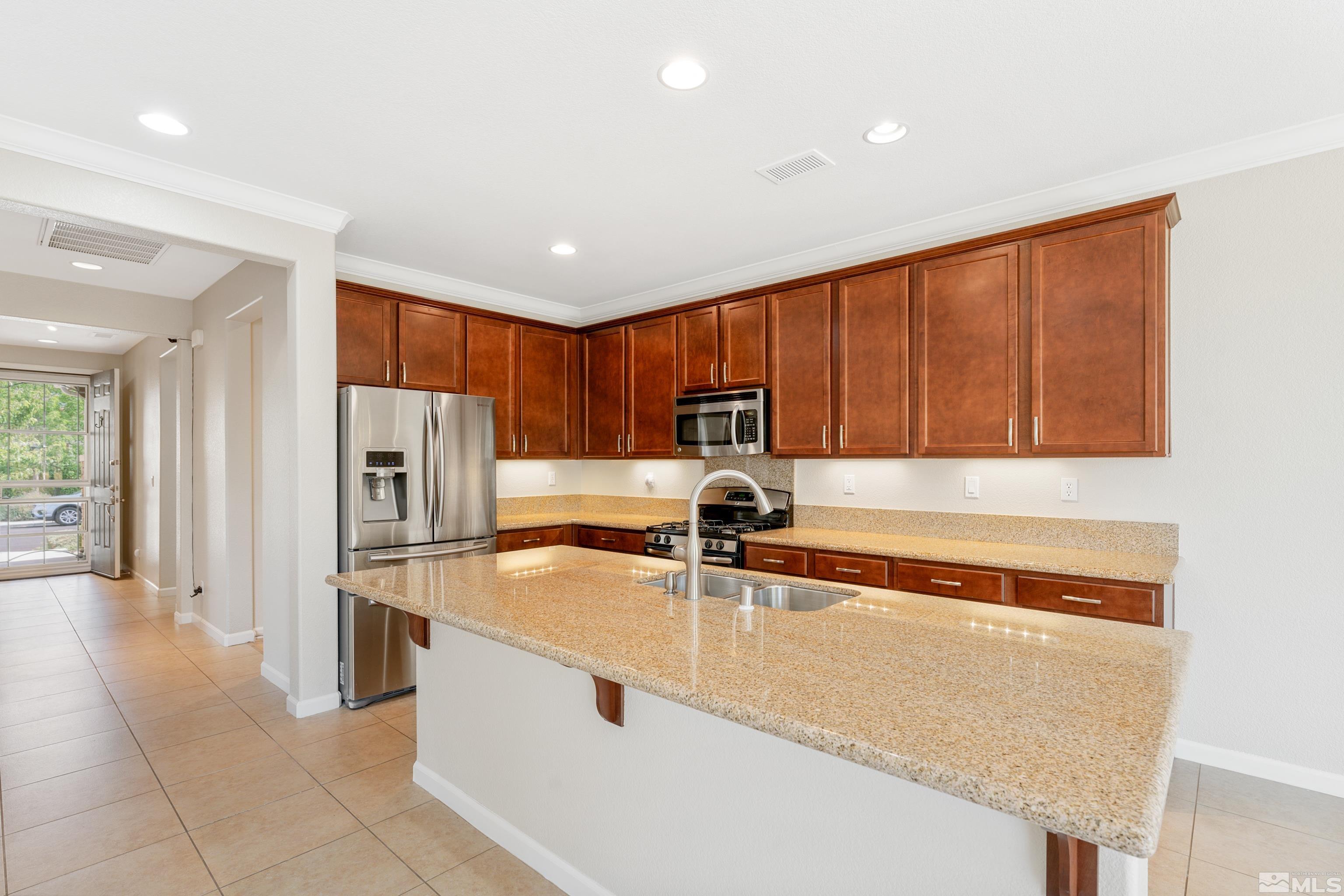 2195 Horse Prairie Road Reno, NV 89521 - Photo 5 of 39 a kitchen with stainless steel appliances granite countertop a refrigerator and a sink