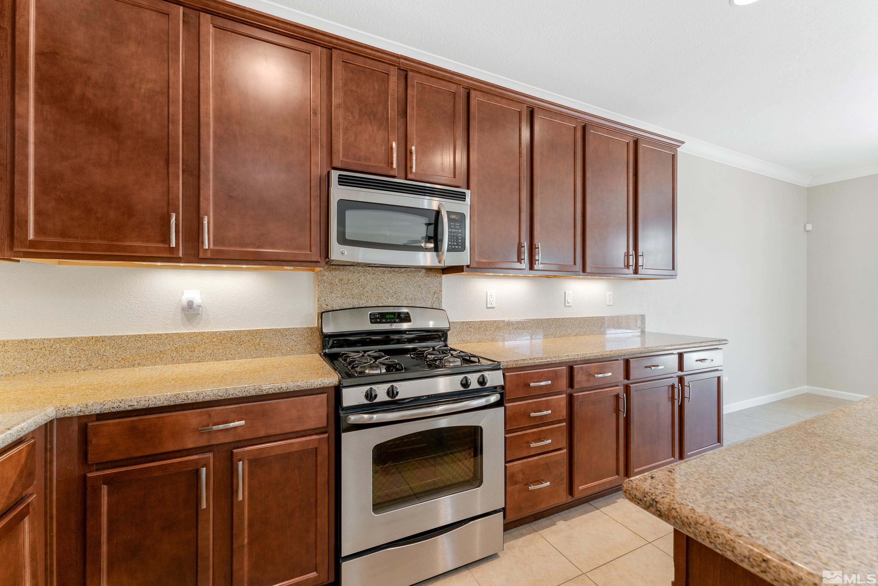 2195 Horse Prairie Road Reno, NV 89521 - Photo 7 of 39 a kitchen with stainless steel appliances a stove microwave and sink