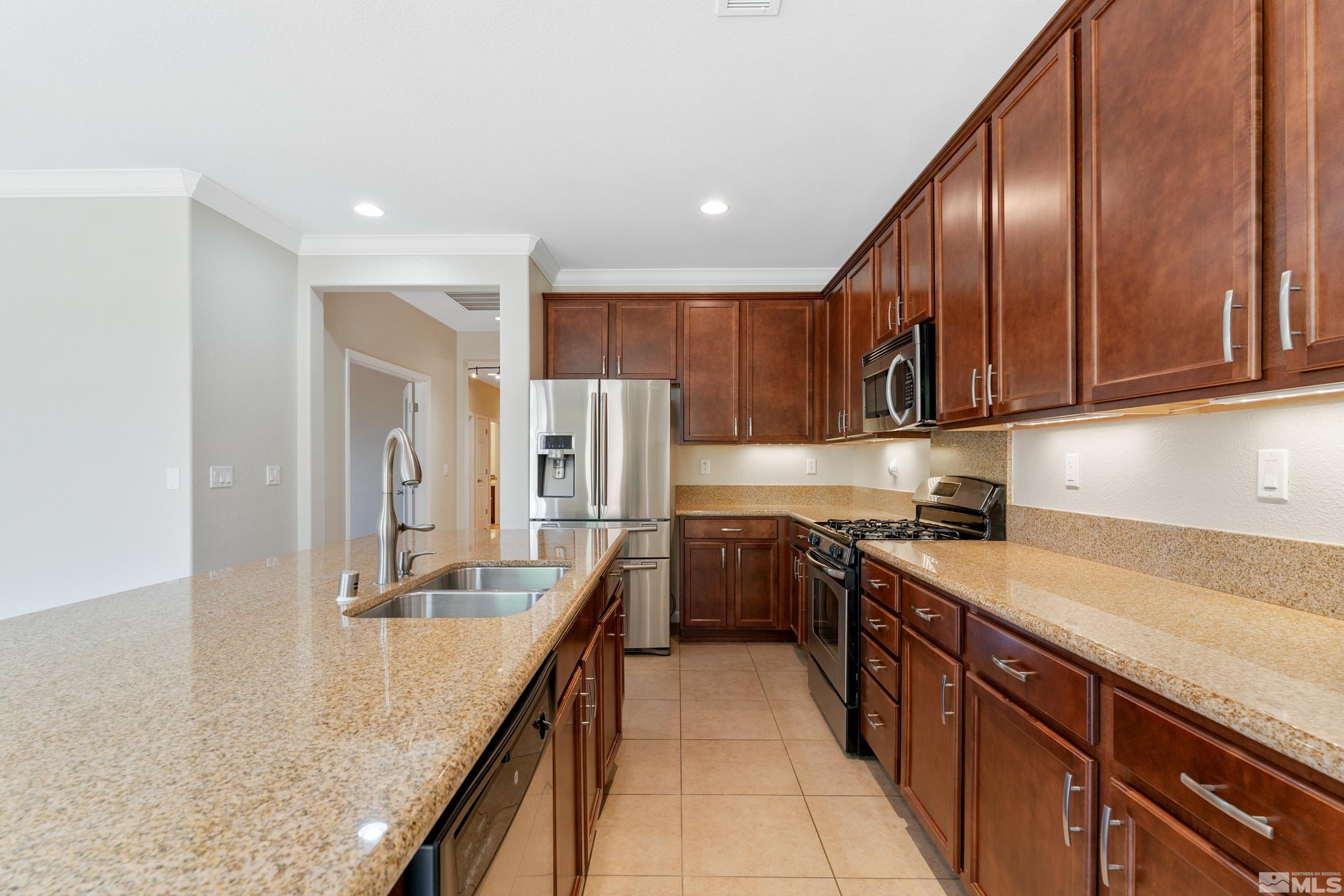 2195 Horse Prairie Road Reno, NV 89521 - Photo 8 of 39 a kitchen with stainless steel appliances granite countertop a sink a stove and a refrigerator