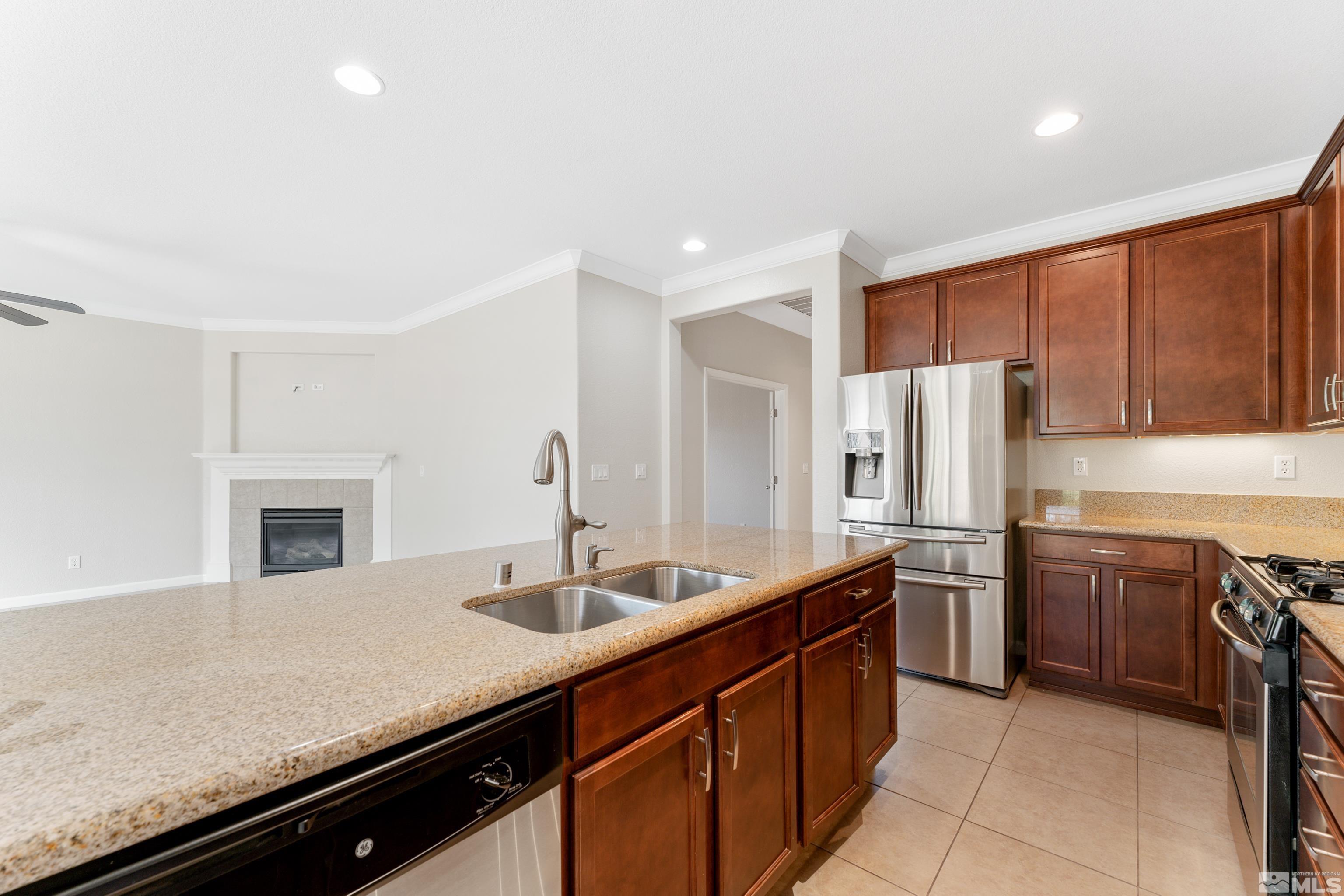 2195 Horse Prairie Road Reno, NV 89521 - Photo 9 of 39 a kitchen with stainless steel appliances granite countertop a sink stove and refrigerator