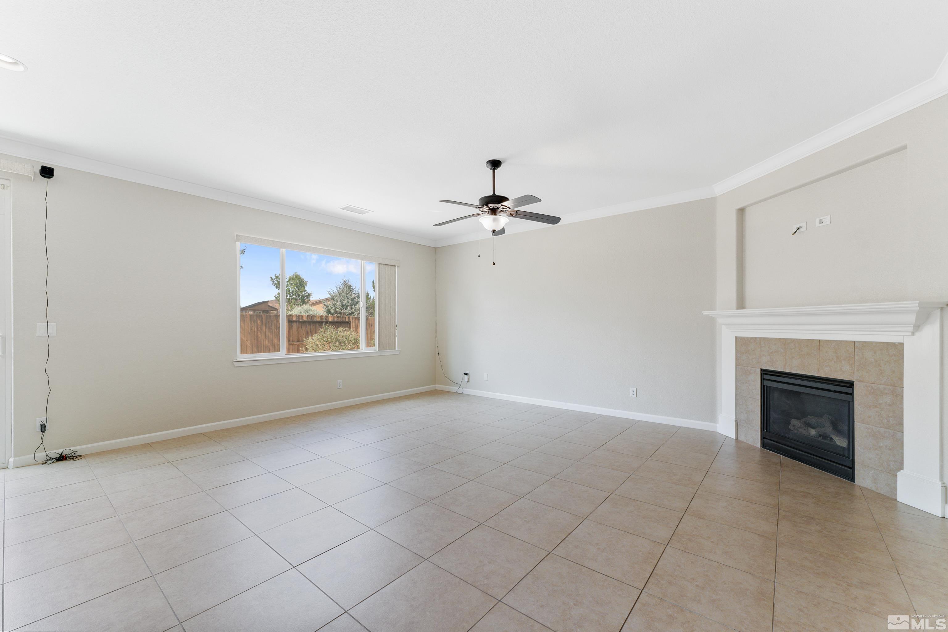 2195 Horse Prairie Road Reno, NV 89521 - Photo 10 of 39 an empty room with windows and fireplace