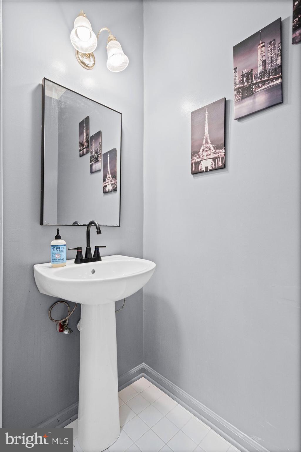 9965 Sherwood Farm Road Owings Mills, MD 21117 - Photo 11 of 35 a bathroom with a sink mirror and vanity