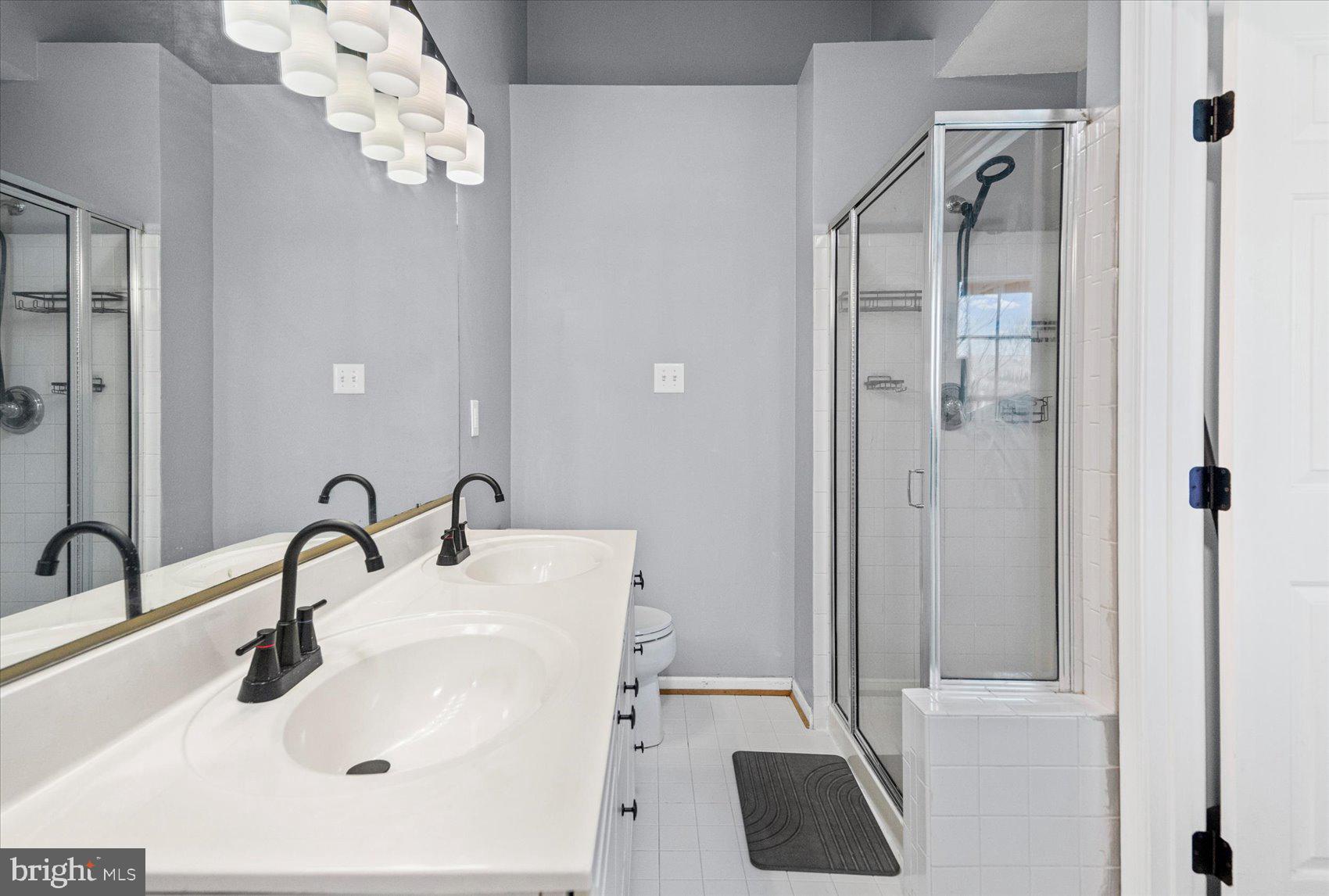 9965 Sherwood Farm Road Owings Mills, MD 21117 - Photo 15 of 35 a bathroom with a sink and mirror