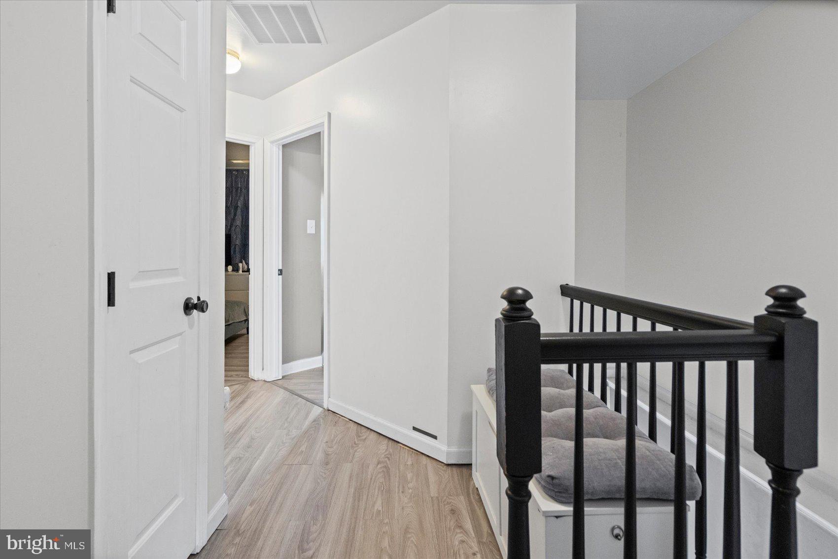 9965 Sherwood Farm Road Owings Mills, MD 21117 - Photo 16 of 35 a view of a hallway with wooden floor