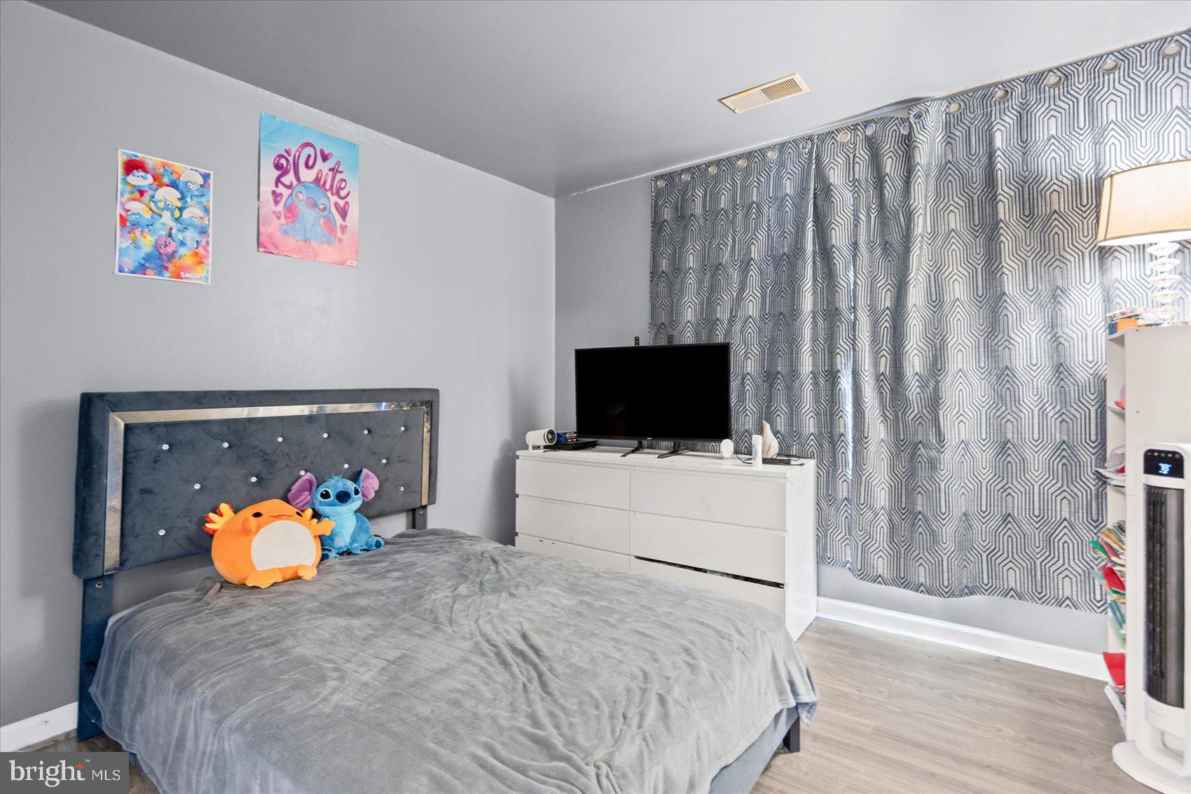 9965 Sherwood Farm Road Owings Mills, MD 21117 - Photo 21 of 35 a bedroom with a bed and a television