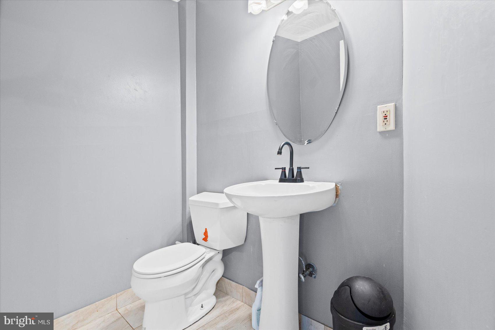 9965 Sherwood Farm Road Owings Mills, MD 21117 - Photo 22 of 35 a bathroom with a sink toilet and mirror