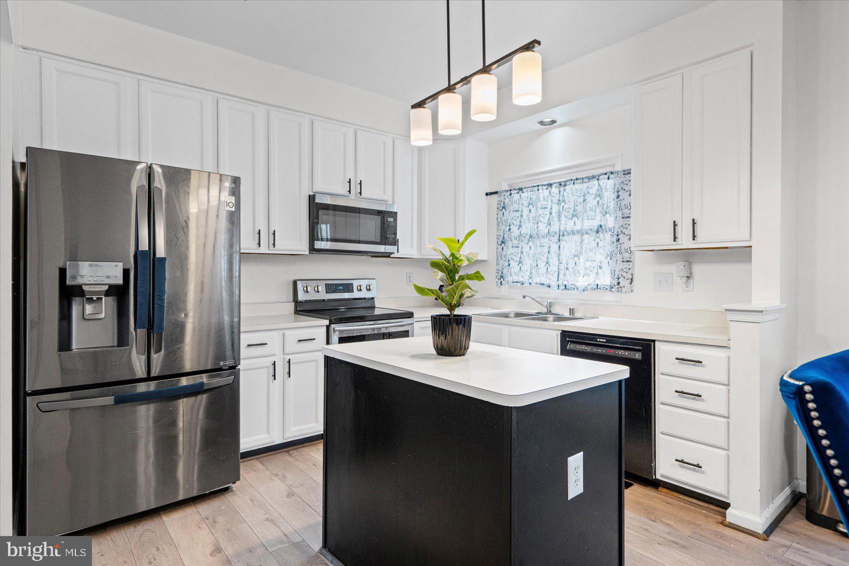 9965 Sherwood Farm Road Owings Mills, MD 21117 - Photo 6 of 35 a kitchen with appliances a sink and a refrigerator
