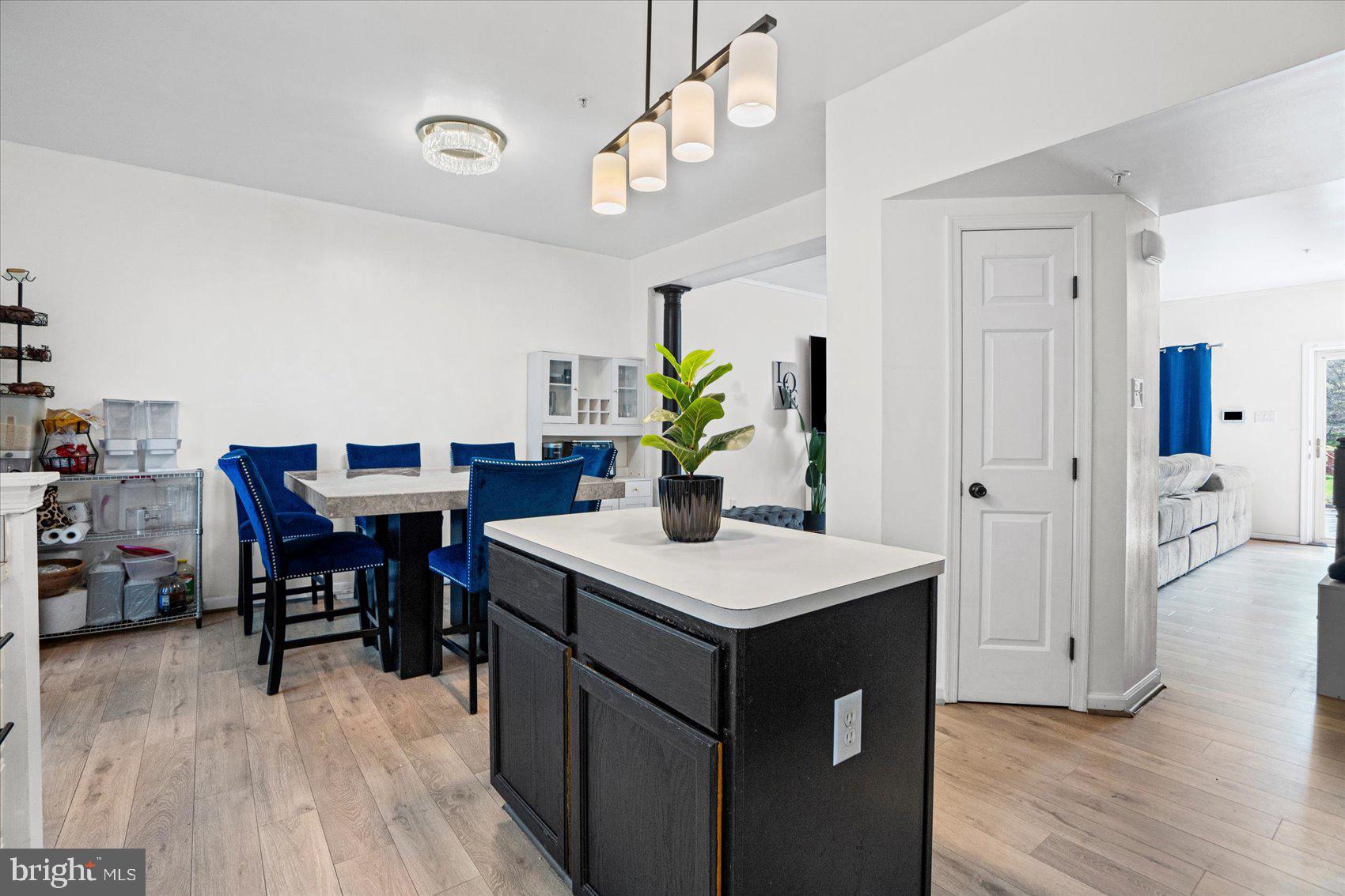 9965 Sherwood Farm Road Owings Mills, MD 21117 - Photo 8 of 35 a view of a dining room with furniture and wooden floor