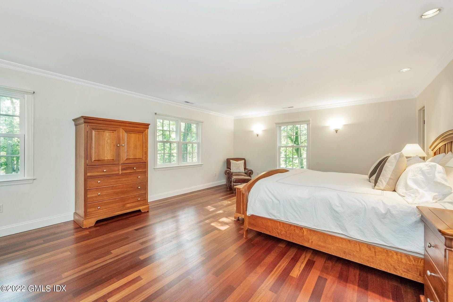 12 Frontier Road Cos Cob, CT 06807 - Photo 12 of 36 a bed room with a bed and a window