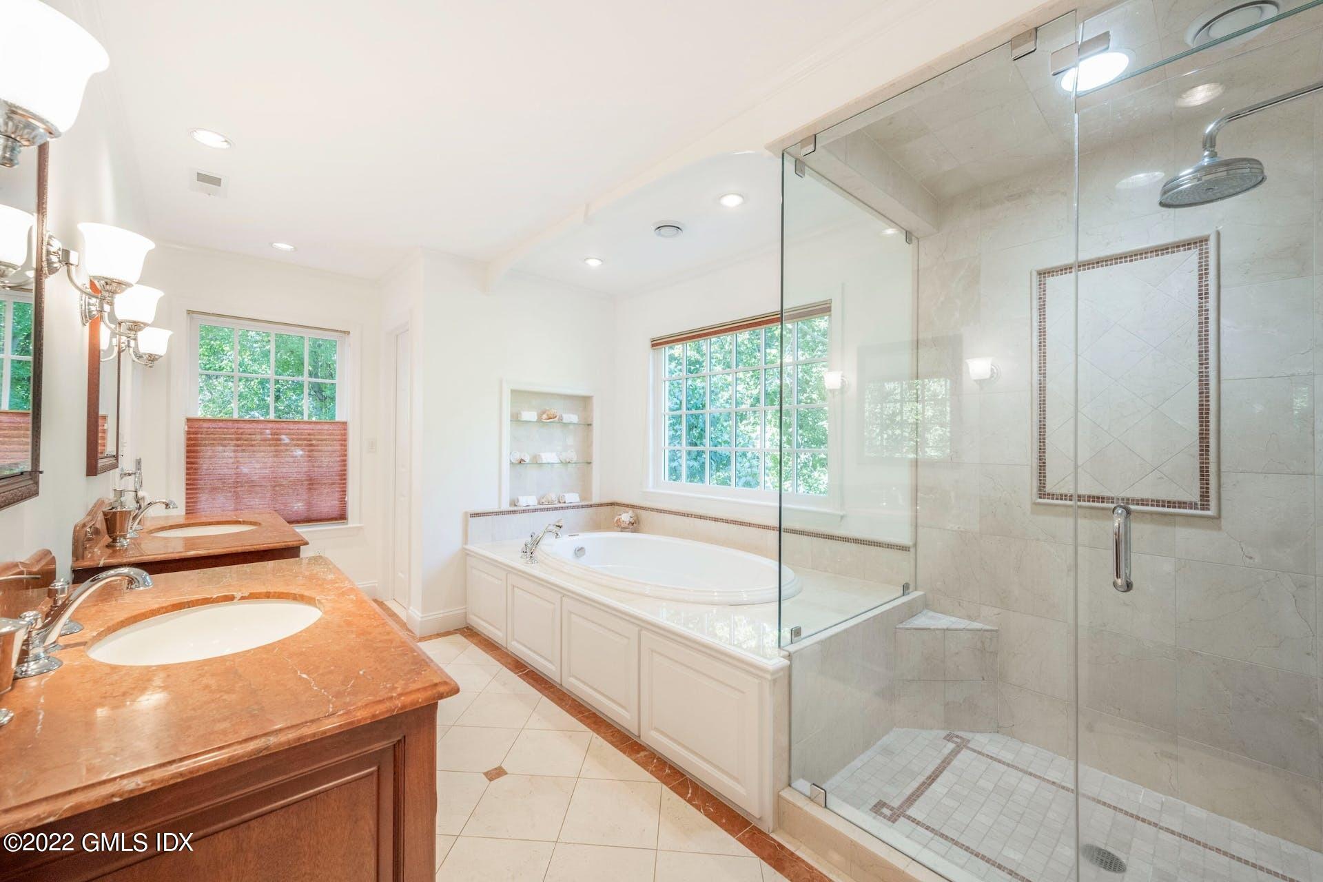 12 Frontier Road Cos Cob, CT 06807 - Photo 13 of 36 a spacious bathroom with a tub sink and mirror