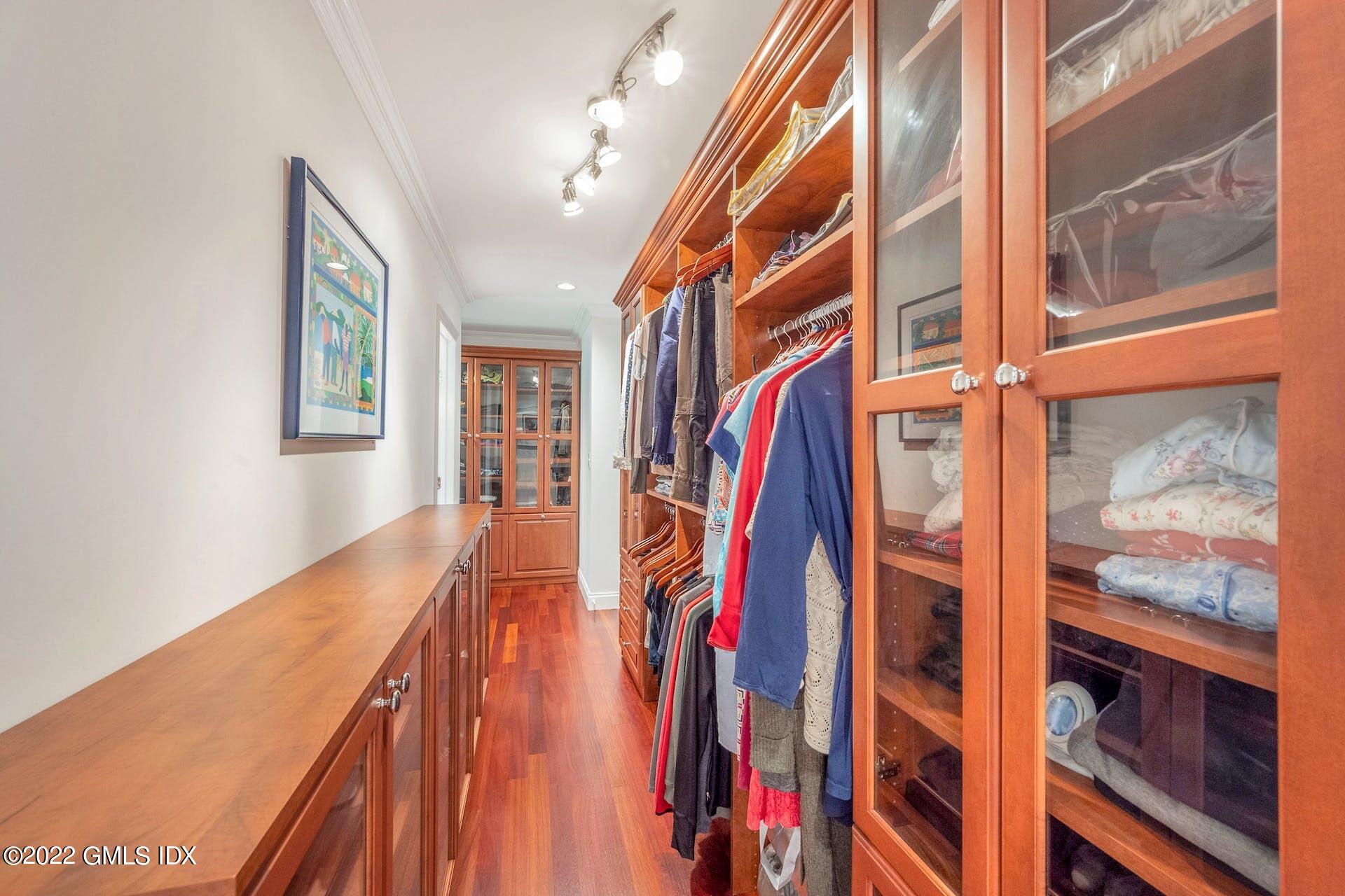 12 Frontier Road Cos Cob, CT 06807 - Photo 15 of 36 a view of walk in closet with clothes and shoes