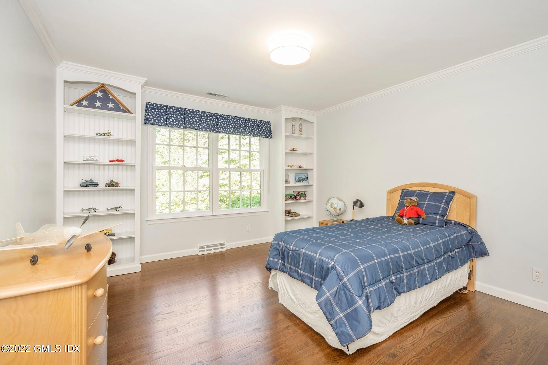12 Frontier Road Cos Cob, CT 06807 - Photo 17 of 36 a bedroom with a bed and a window