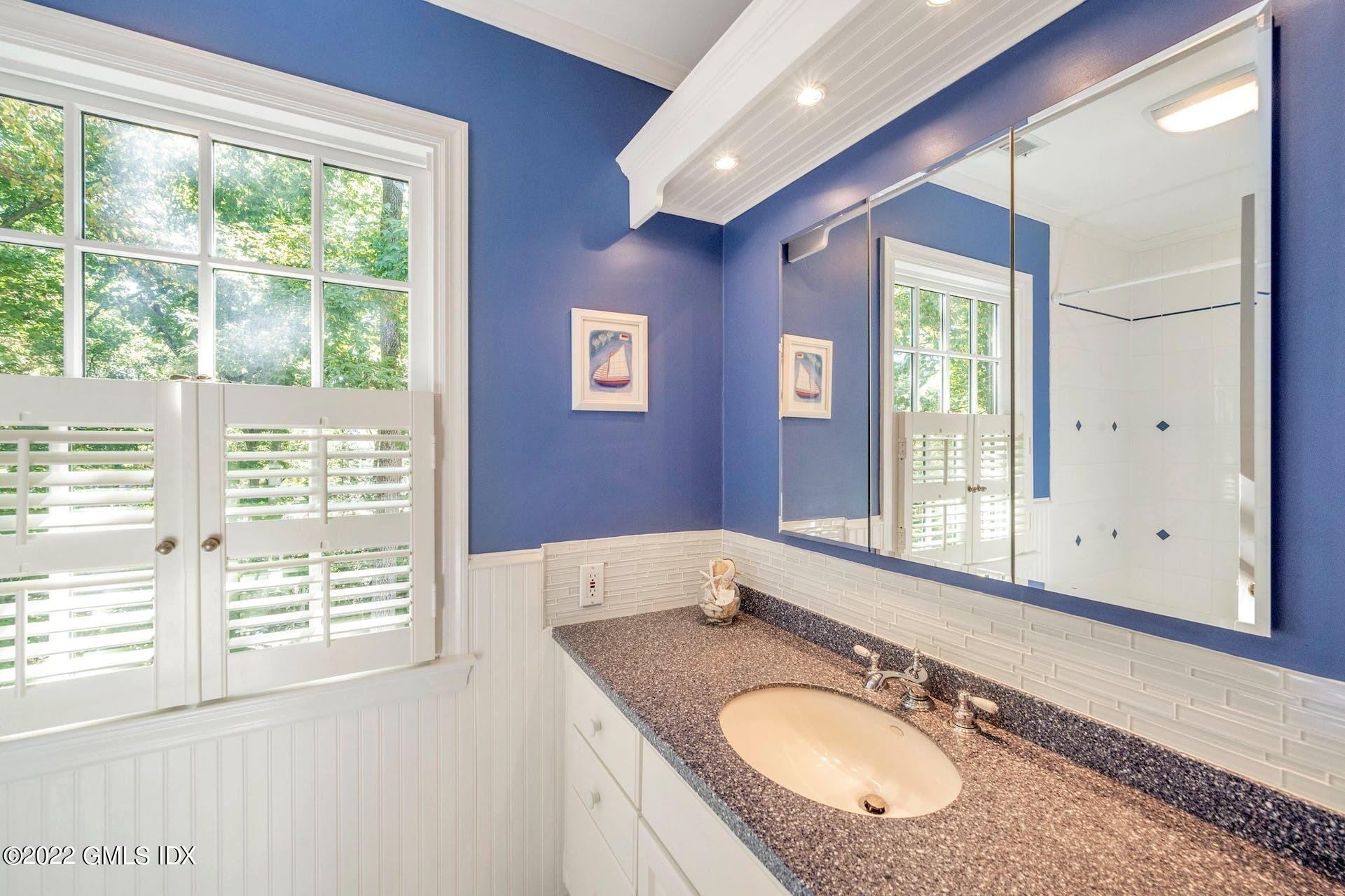 12 Frontier Road Cos Cob, CT 06807 - Photo 21 of 36 a bathroom with a granite countertop sink and a large mirror