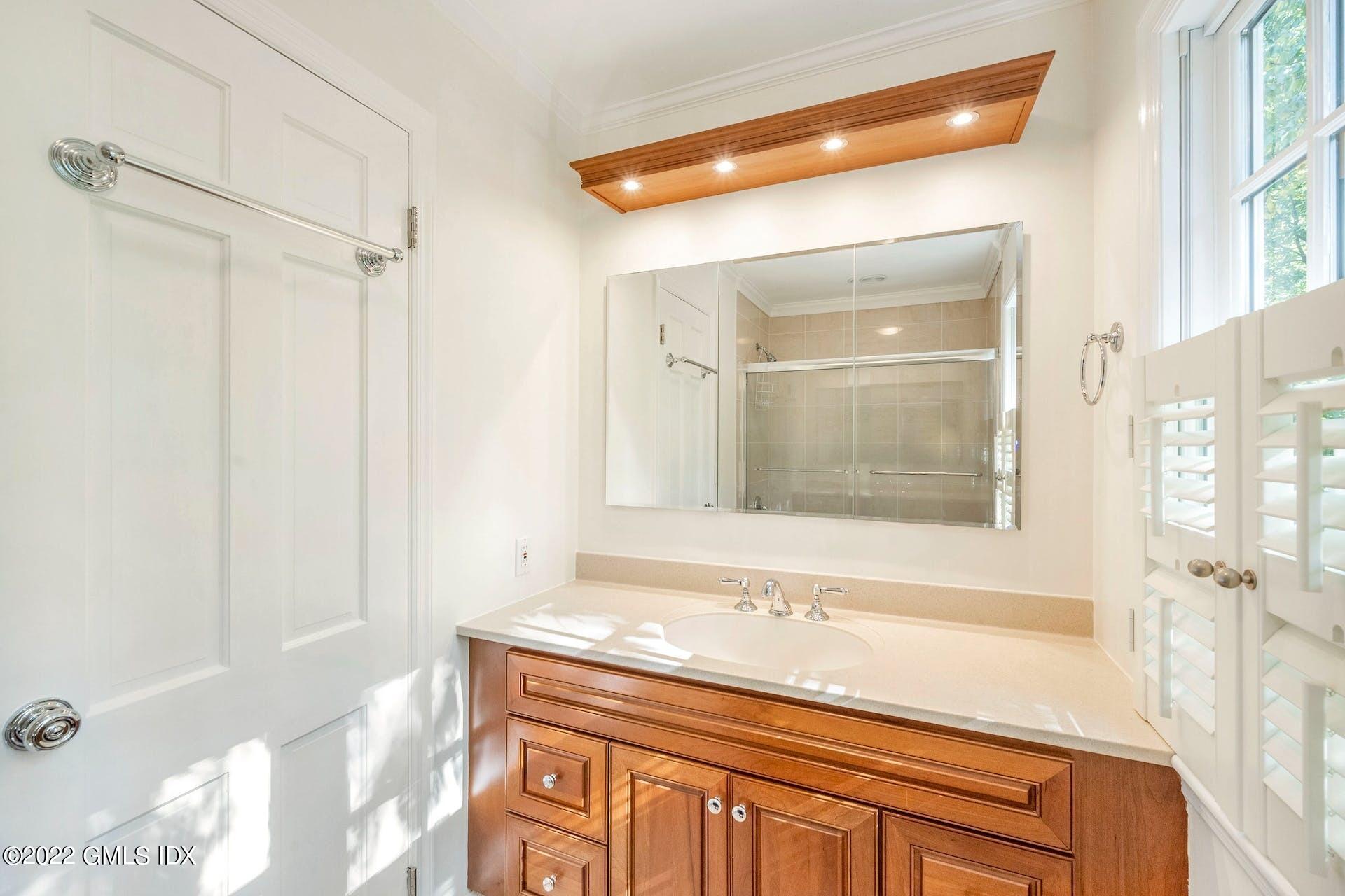 12 Frontier Road Cos Cob, CT 06807 - Photo 22 of 36 a bathroom with a granite countertop sink mirror and a bathtub