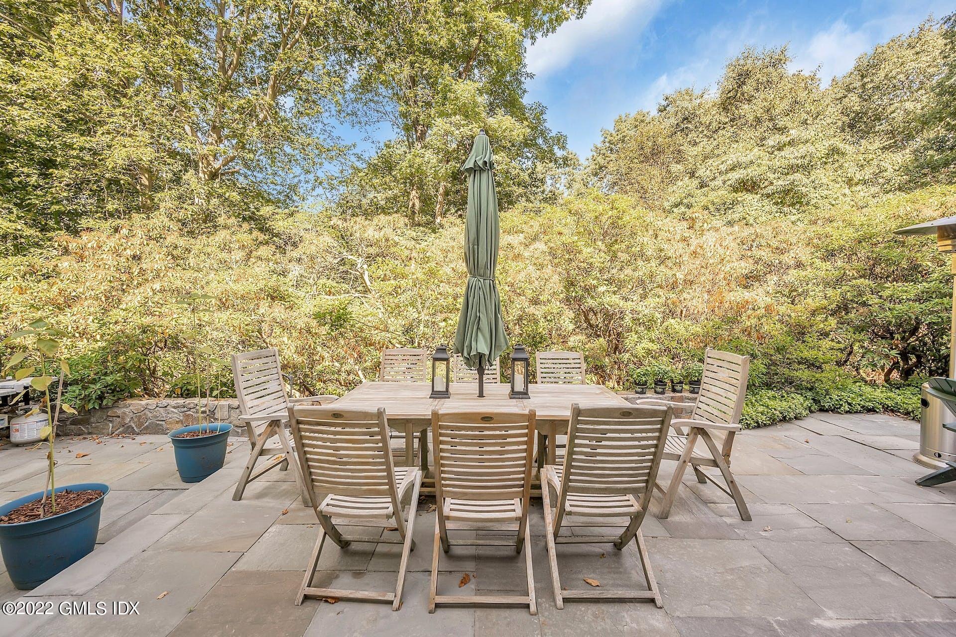 12 Frontier Road Cos Cob, CT 06807 - Photo 27 of 36 a patio with table and chairs and potted plants