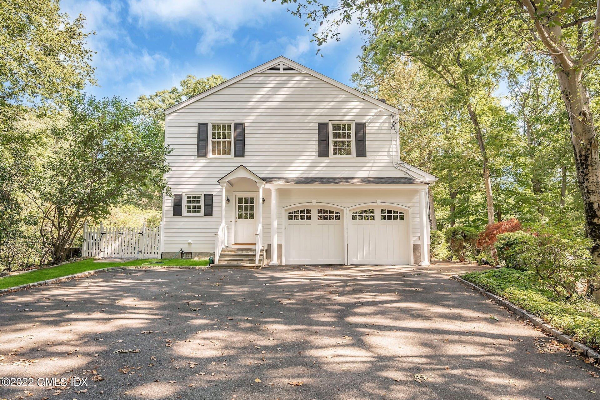 12 Frontier Road Cos Cob, CT 06807 - Photo 31 of 36 a view of a white house with a big yard and large trees