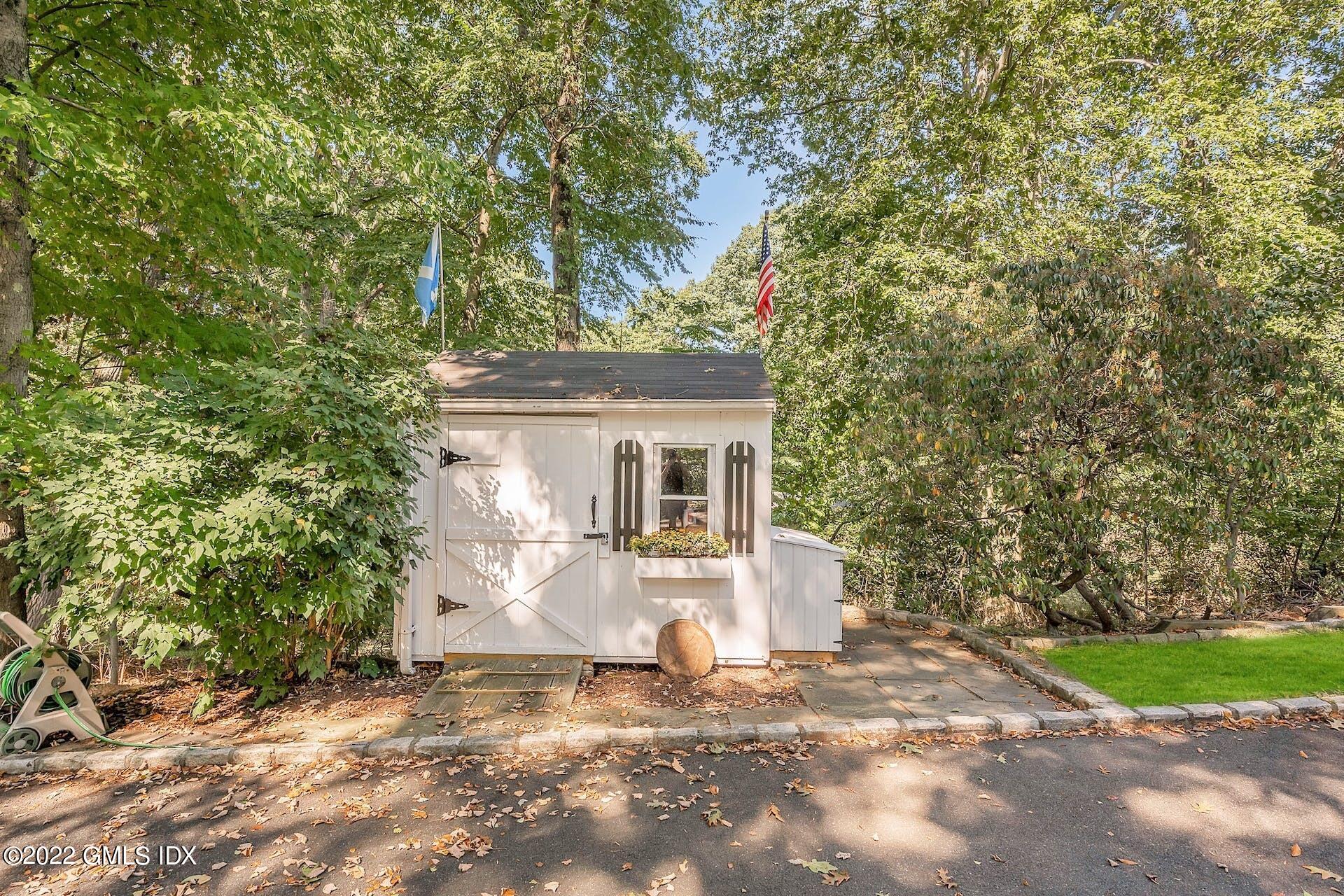 12 Frontier Road Cos Cob, CT 06807 - Photo 32 of 36 a view of a house with a tree and plants