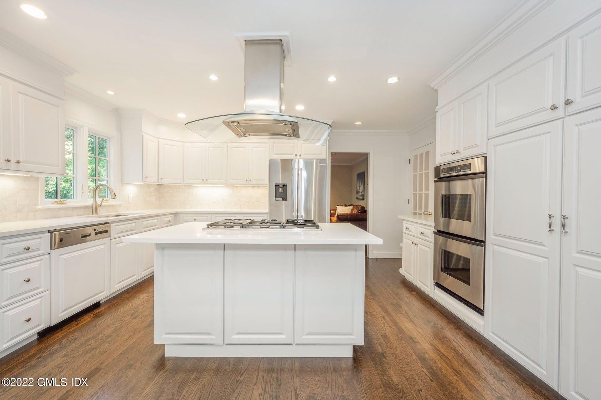 12 Frontier Road Cos Cob, CT 06807 - Photo 5 of 36 a kitchen with kitchen island granite countertop a sink cabinets and stainless steel appliances