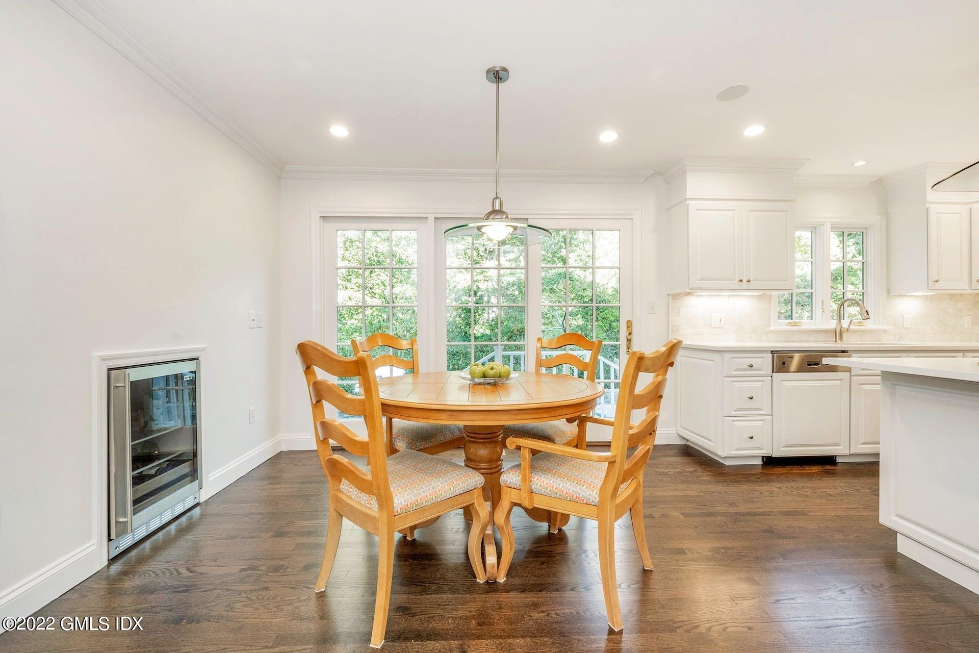 12 Frontier Road Cos Cob, CT 06807 - Photo 7 of 36 a dining room with furniture a chandelier and wooden floor
