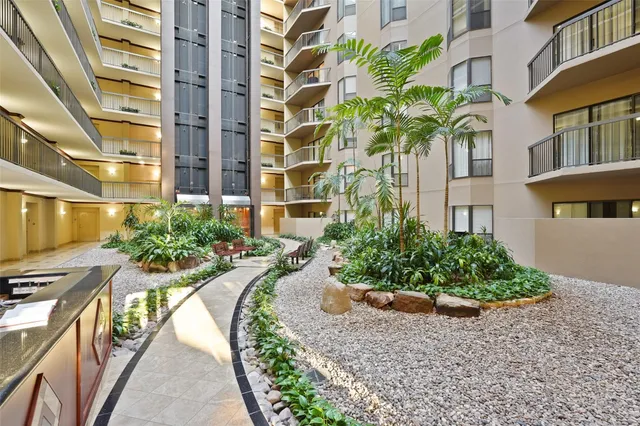 a view of a tall building next to a road