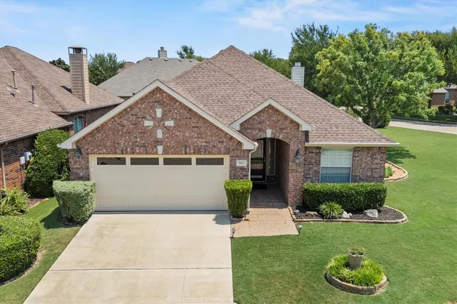 a front view of a house with a garden and plants