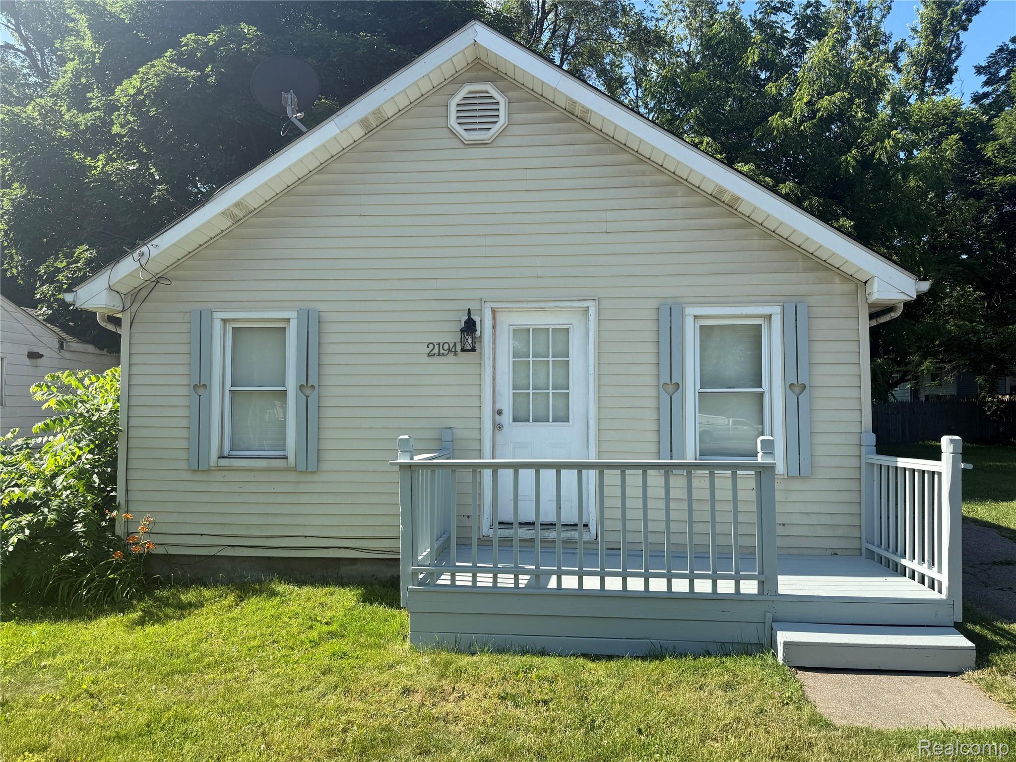 2194 East Bristol Road Burton, MI 48529 - Photo 1 of 6 Siding exterior featuring a front porch with railing and steps