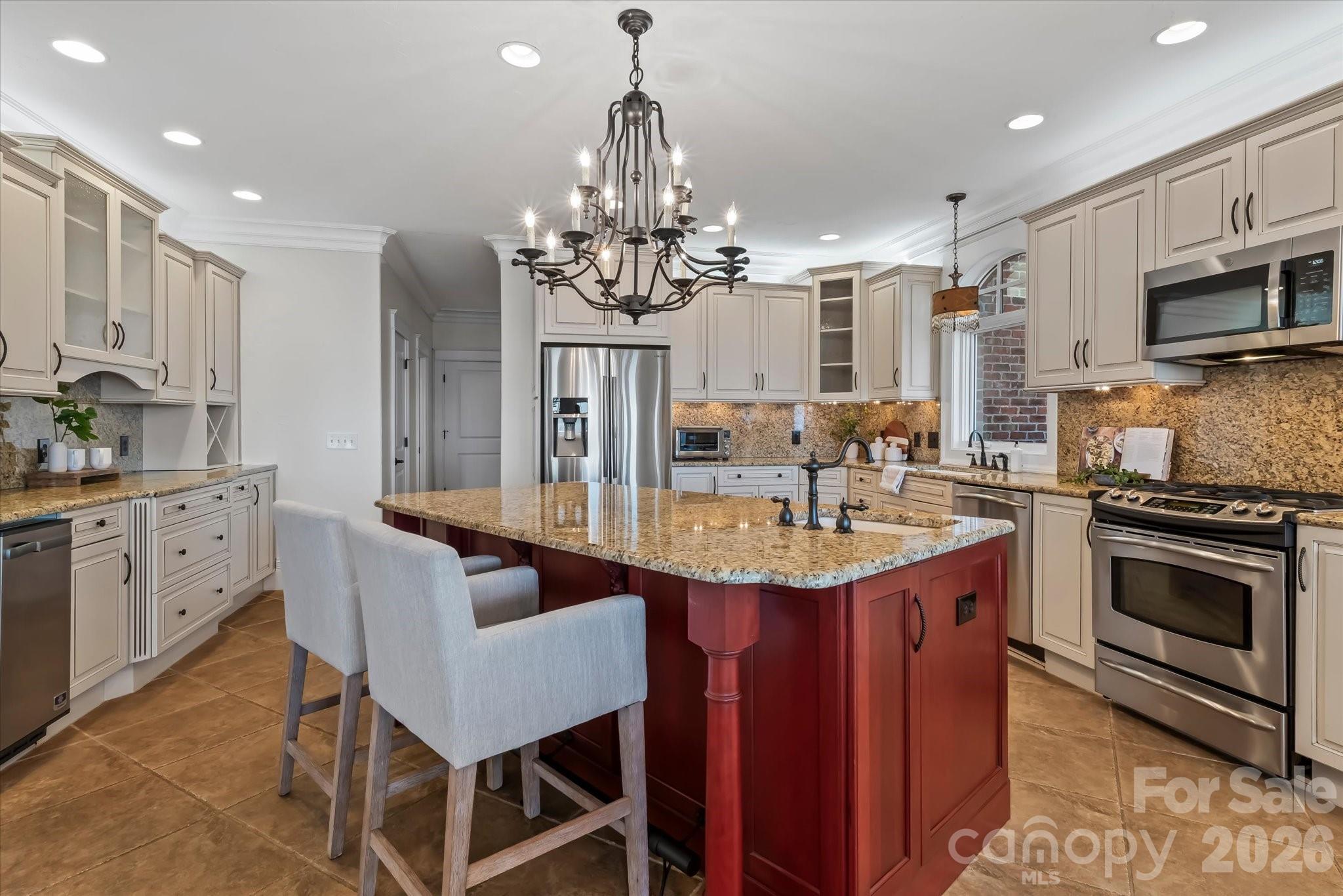 17821 Carlow Road Cornelius, NC 28031 - Photo 12 of 45 a kitchen with stainless steel appliances granite countertop a sink a stove a dining table and chairs