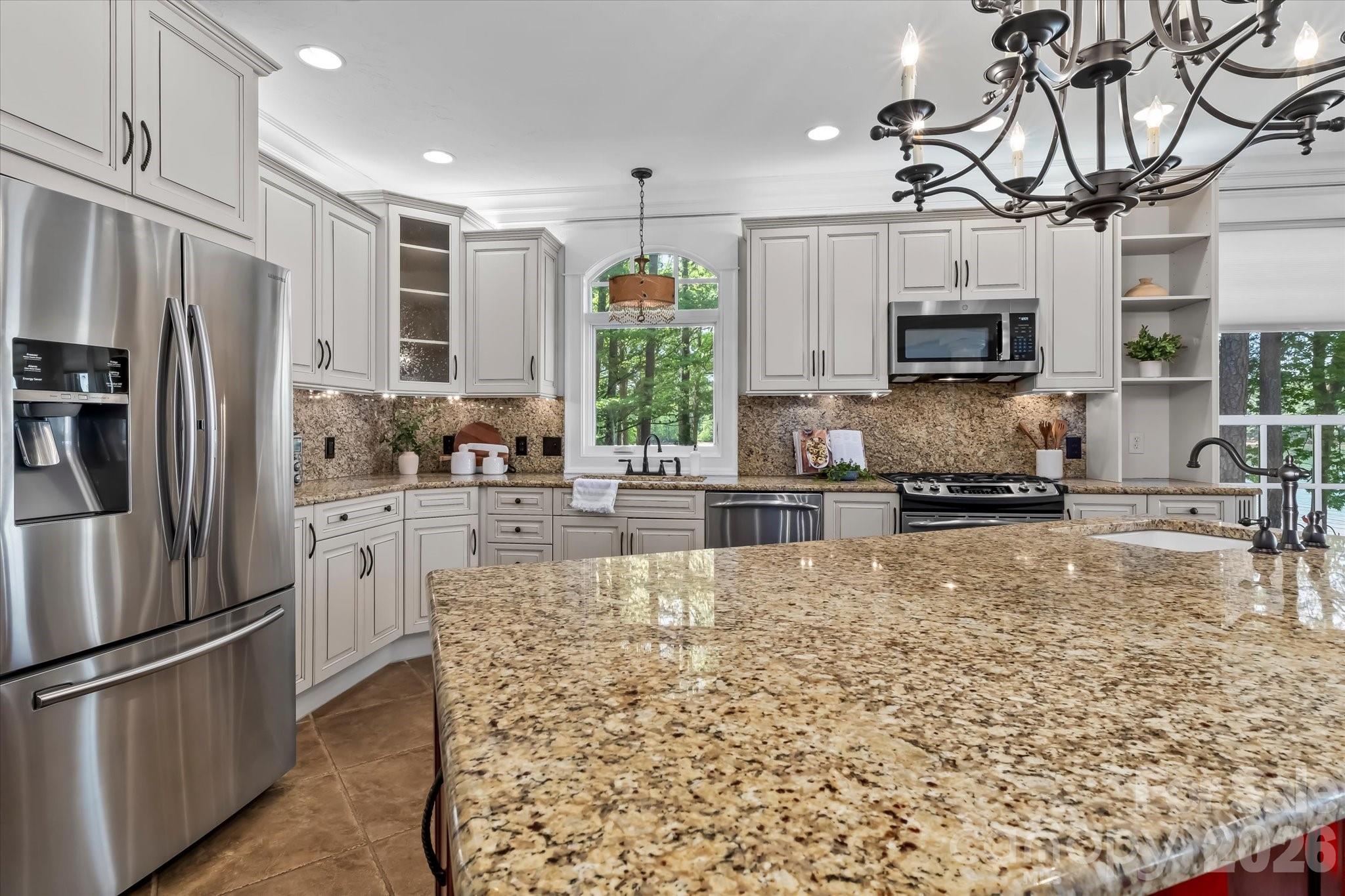 17821 Carlow Road Cornelius, NC 28031 - Photo 13 of 45 a kitchen with stainless steel appliances granite countertop a refrigerator a stove a microwave oven a sink and dishwasher