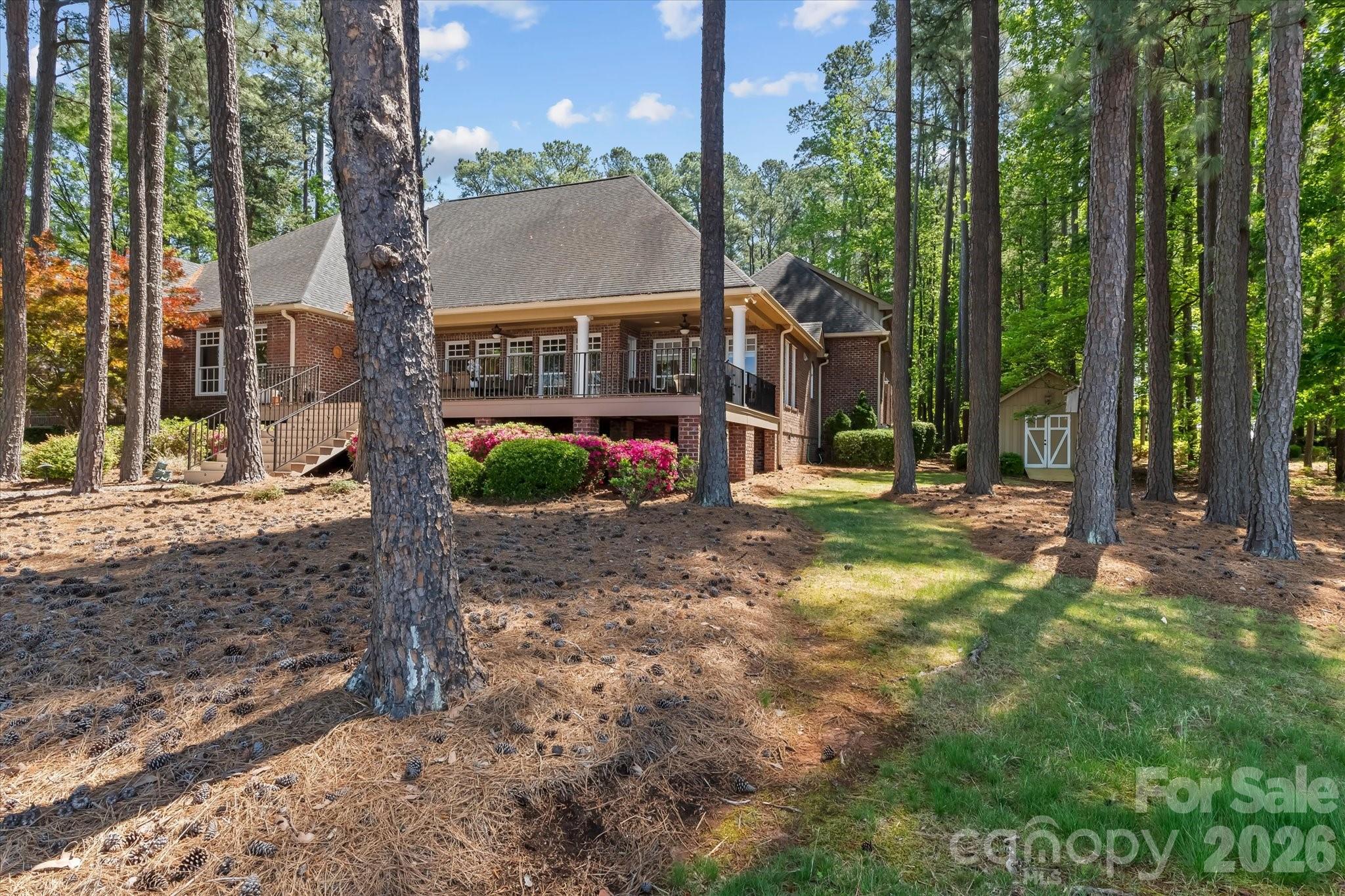 17821 Carlow Road Cornelius, NC 28031 - Photo 35 of 45 a view of a house with a small yard and large trees