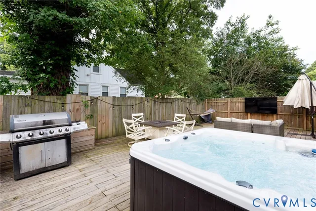 a view of a patio with table and chairs a barbeque with wooden fence