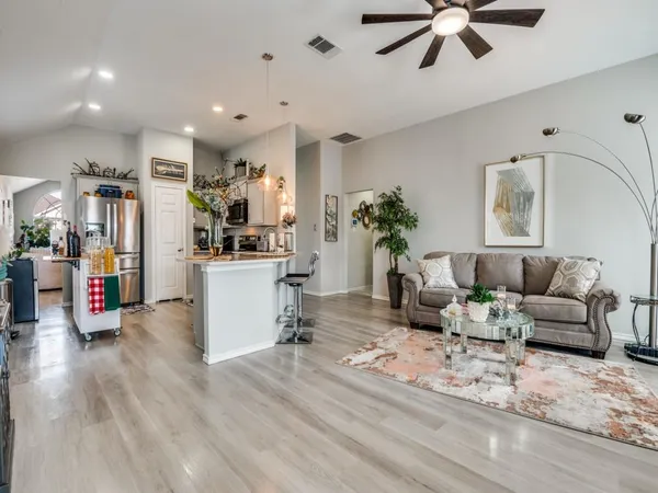a living room with furniture and a wooden floor