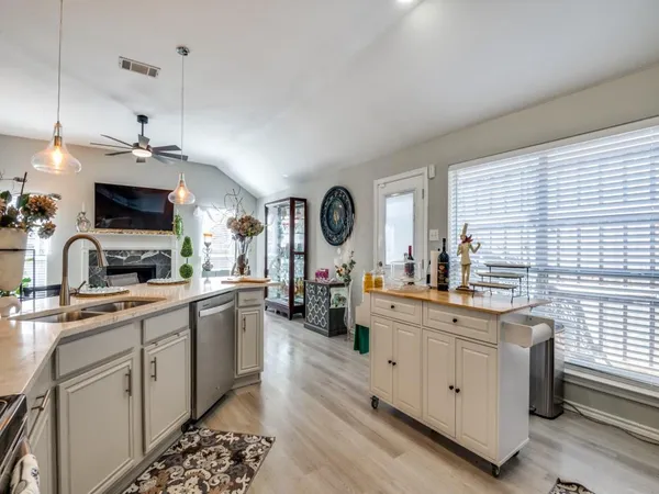 a kitchen with cabinets a sink and appliances