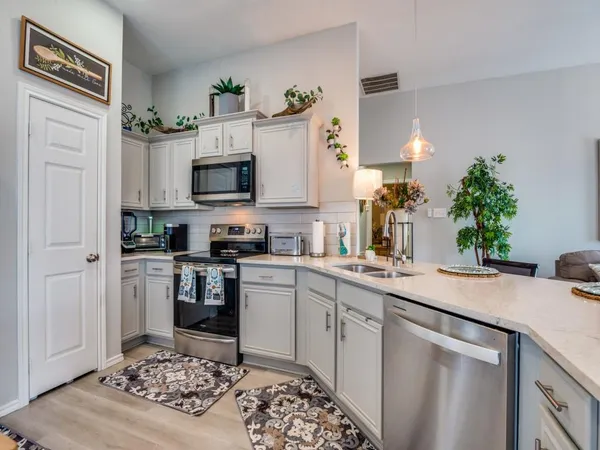 a kitchen with a sink stove and refrigerator