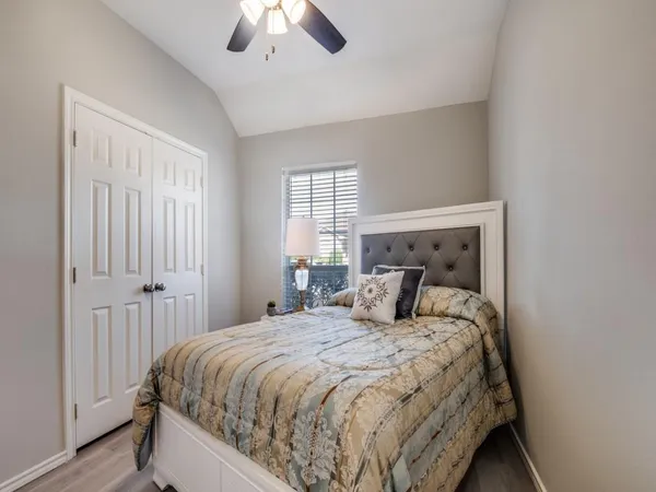 a bedroom with a large bed and a chandelier