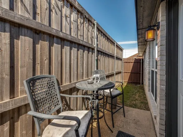 a view of a chairs and table in the balcony