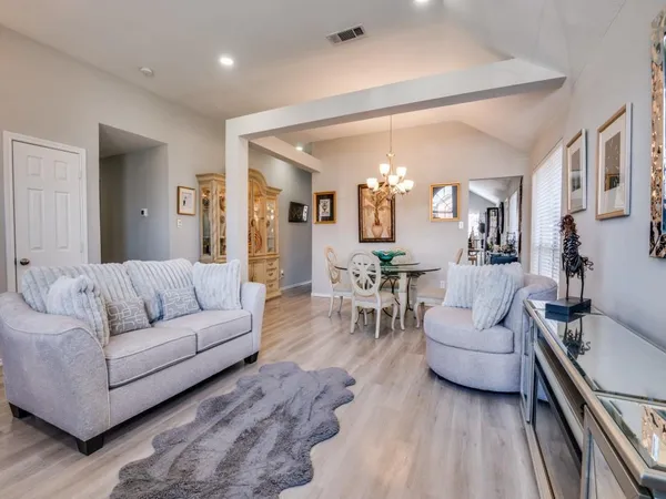 a living room with furniture and view of kitchen