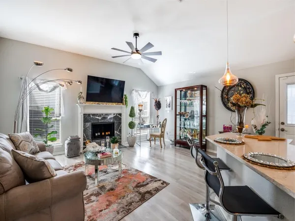 a living room with furniture a fireplace and a flat screen tv